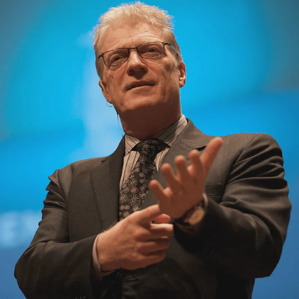 A photo of Sir Ken Robinson speaking on stage.